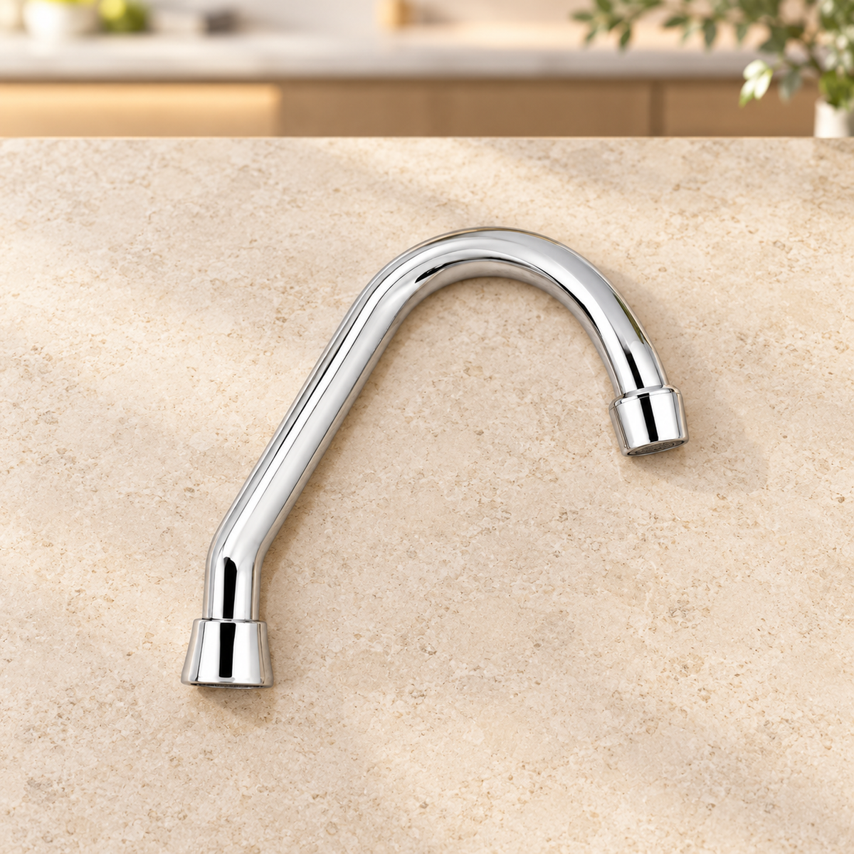 Cuello cisne plástico cromado para grifería suelto sobre piedra cálida antes de instalar; accesorios del ambiente no incluidos.